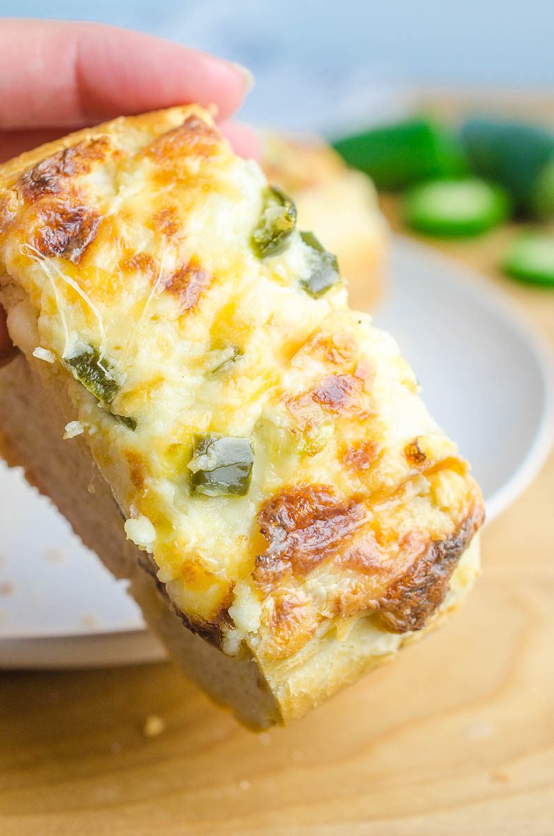 Jalapeno Popper Cheese Bread is everyone's favorite happy hour snack in cheese bread form. Spicy jalapenos, 3 different cheeses and crusty bread. It doesn't get much better! 