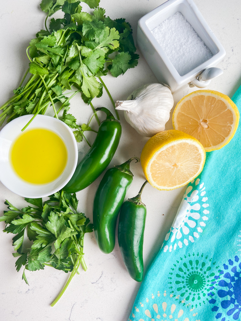 Overhead photo of ingredients for jalapeno salsa on a white background. 