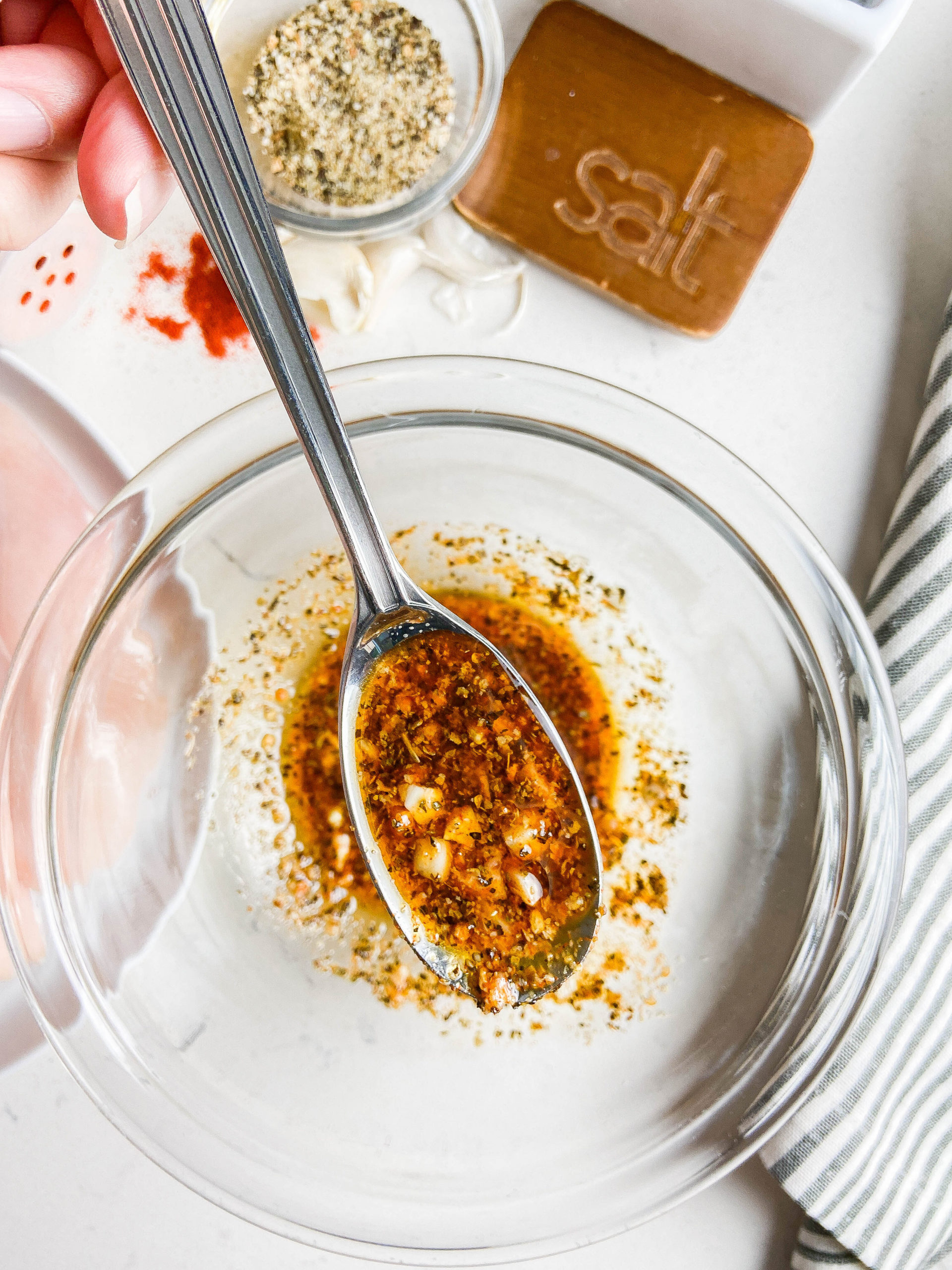 A spoonful of lemon pepper chicken marinade