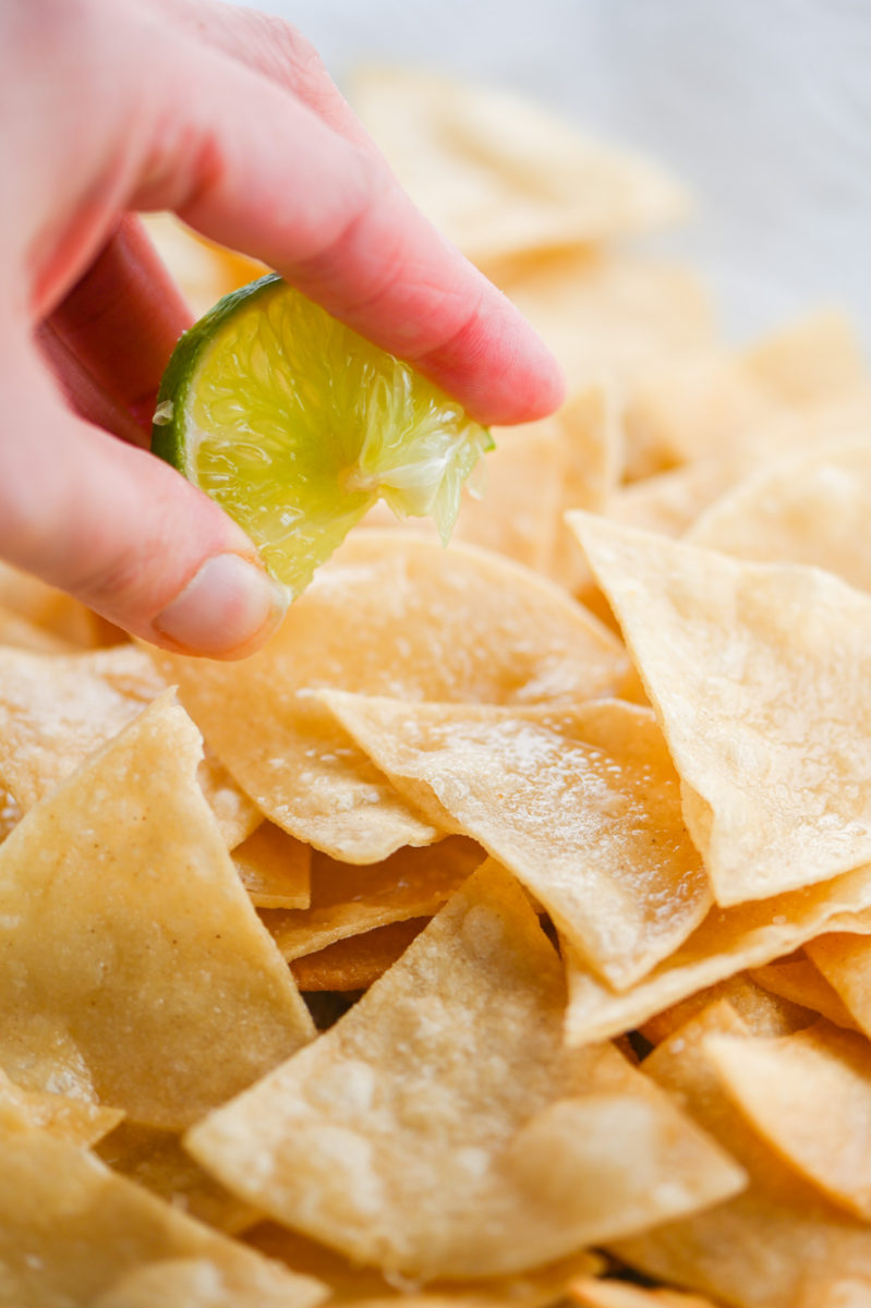 Squirting lime on Lime Tortilla Chips. 
