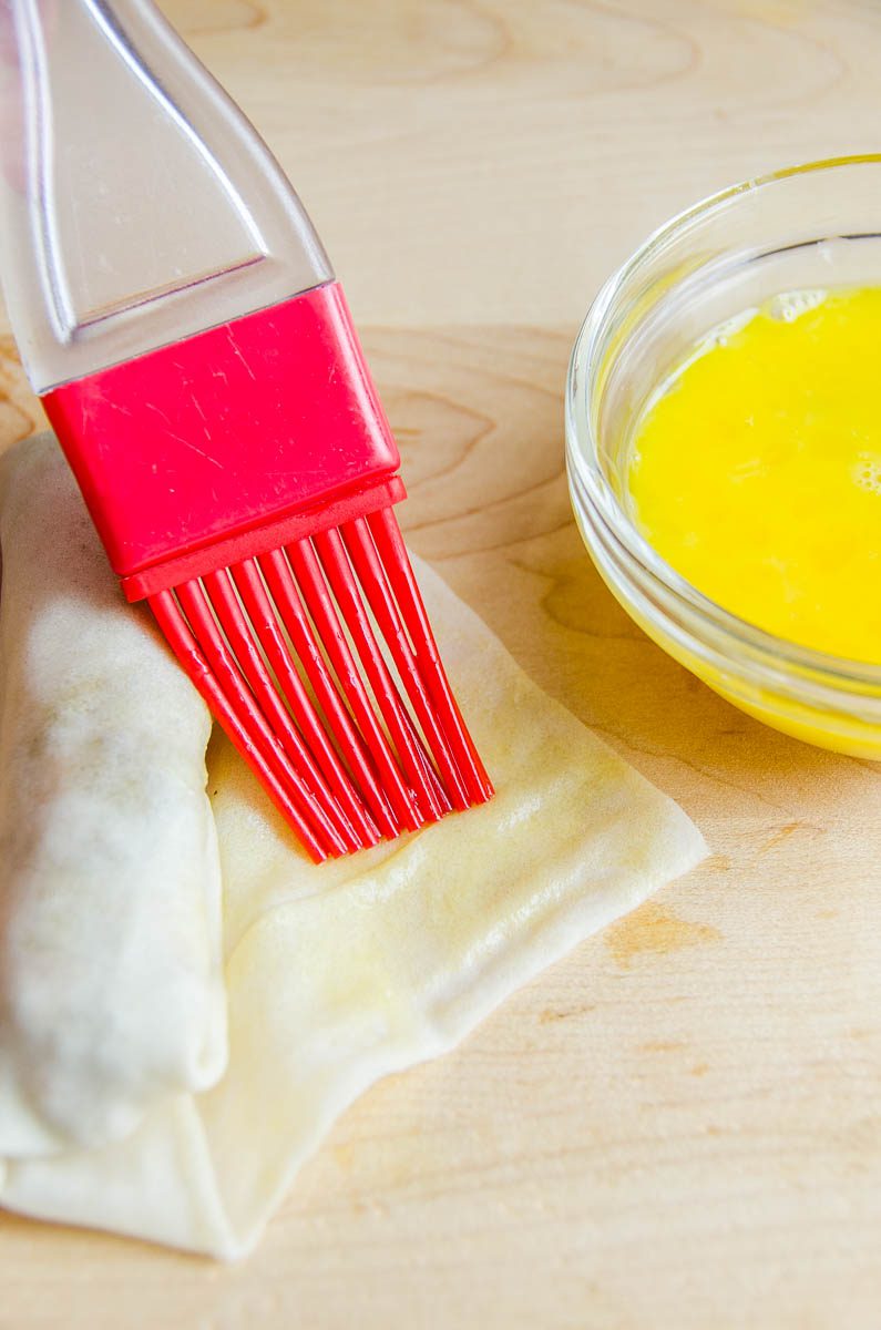 Sealing lumpia with egg. 