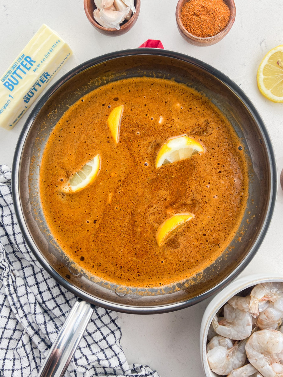 Steamed shrimp broth in skillet.