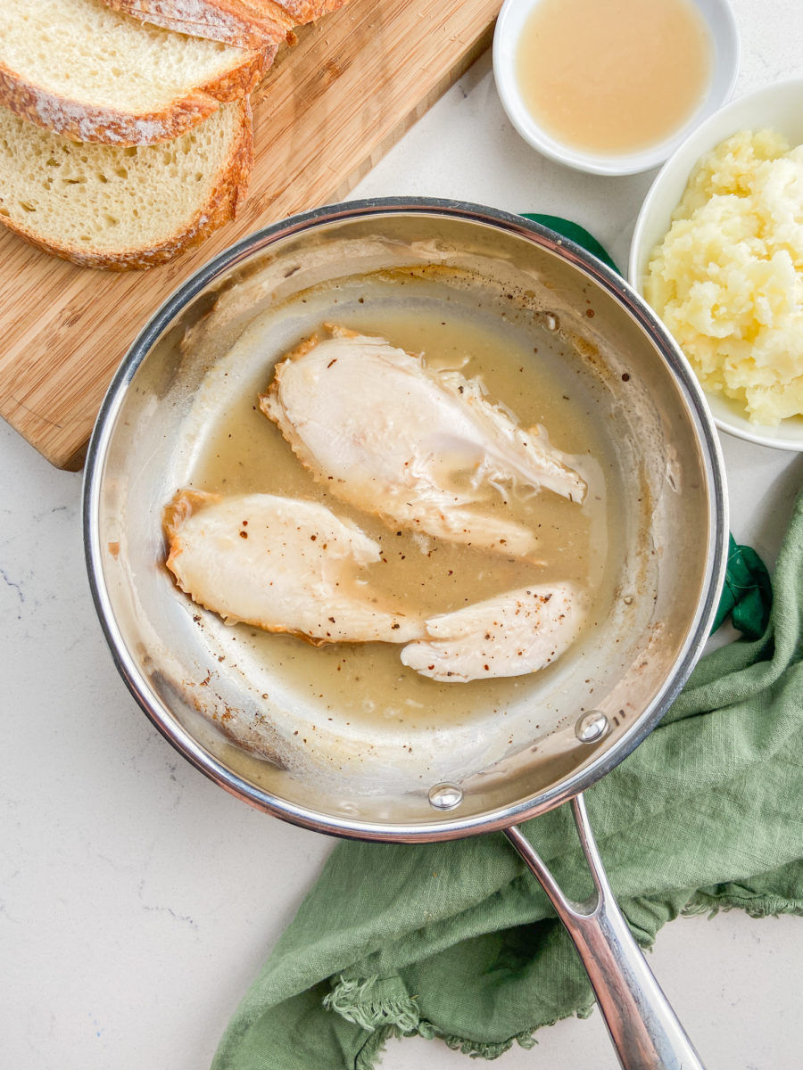 Turkey slices and gravy in saucepan. 