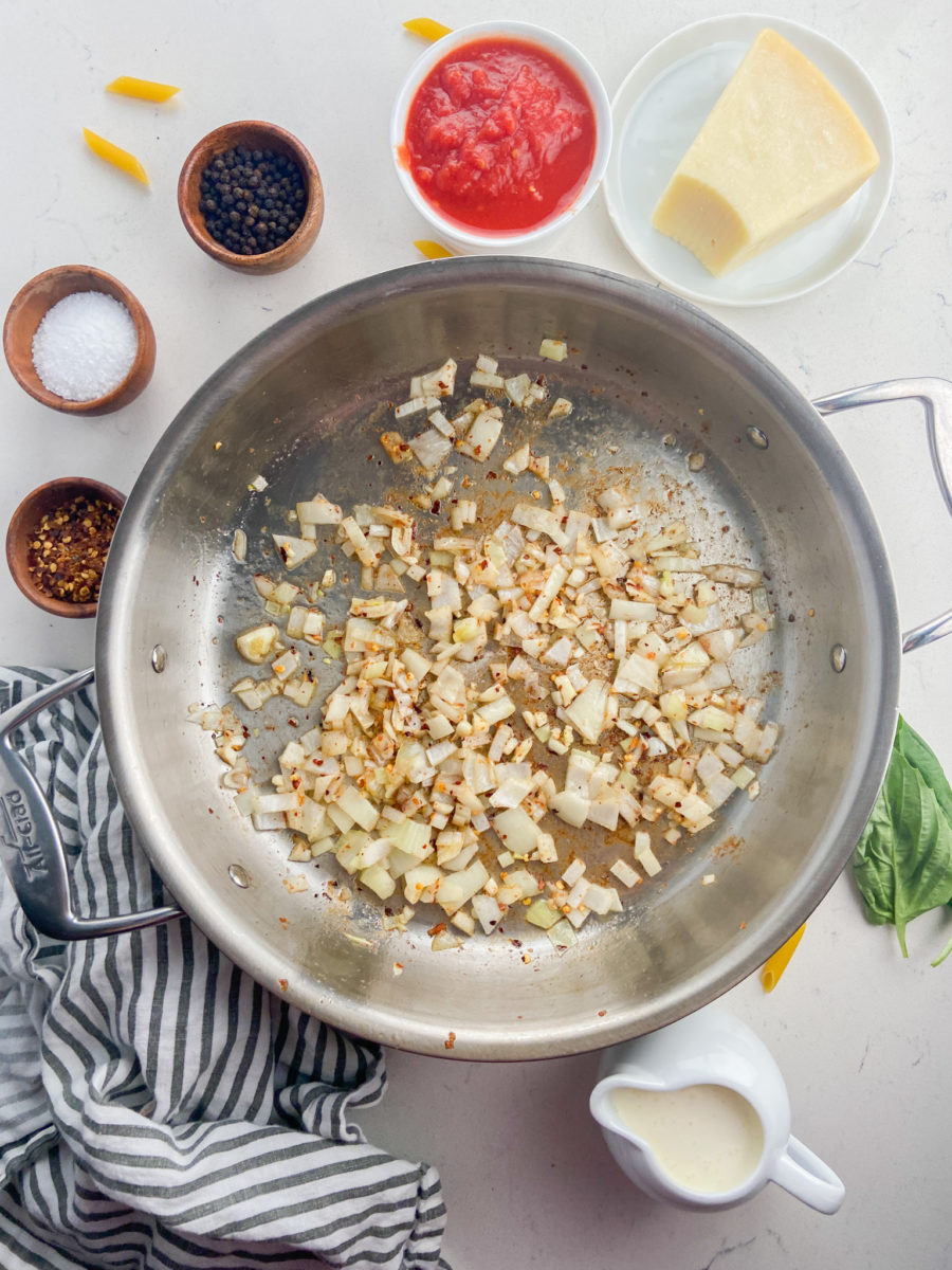 Cooking onions and garlic in stainless steel pan.