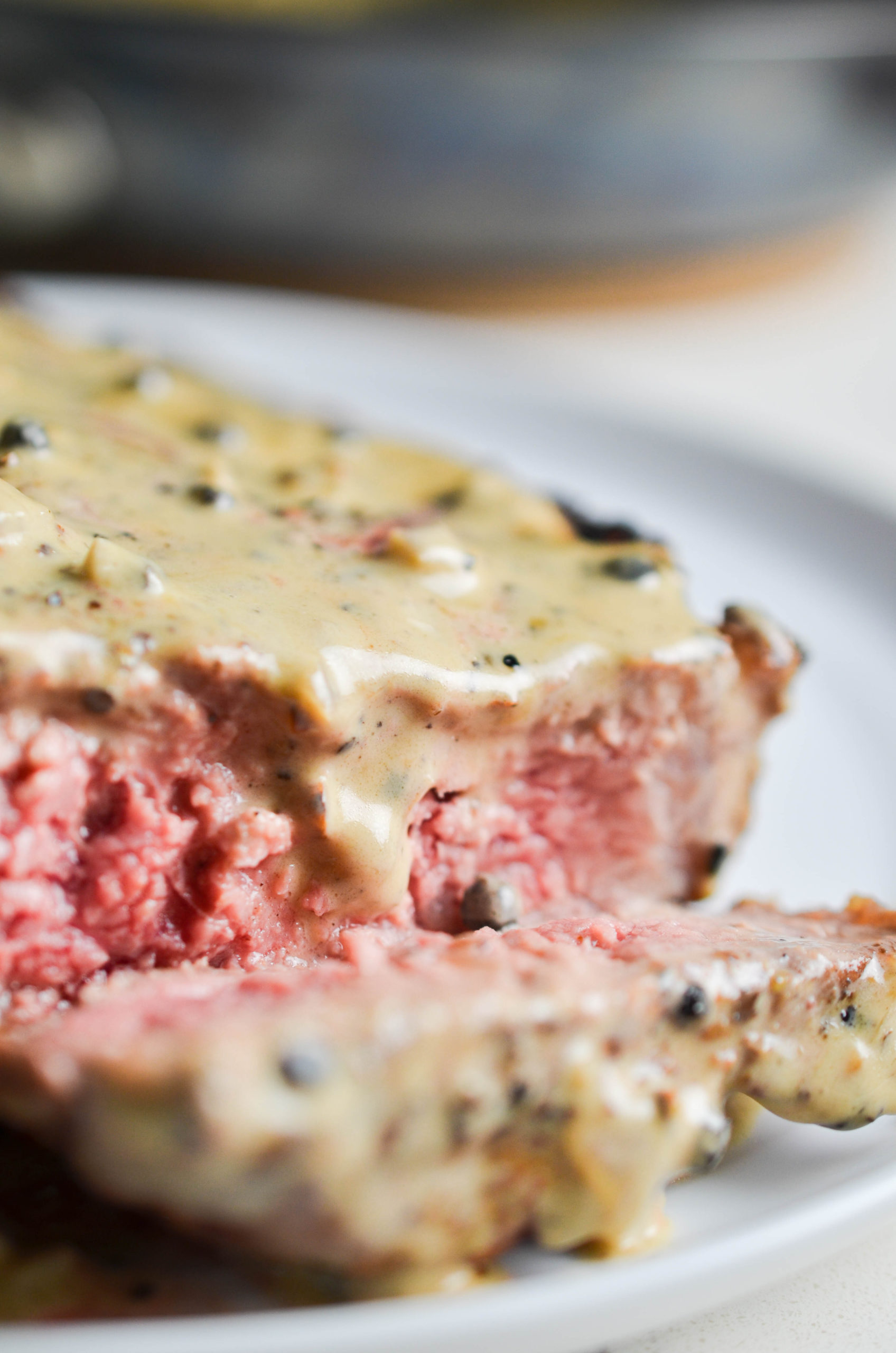 Peppercorn sauce on a sliced steak. 