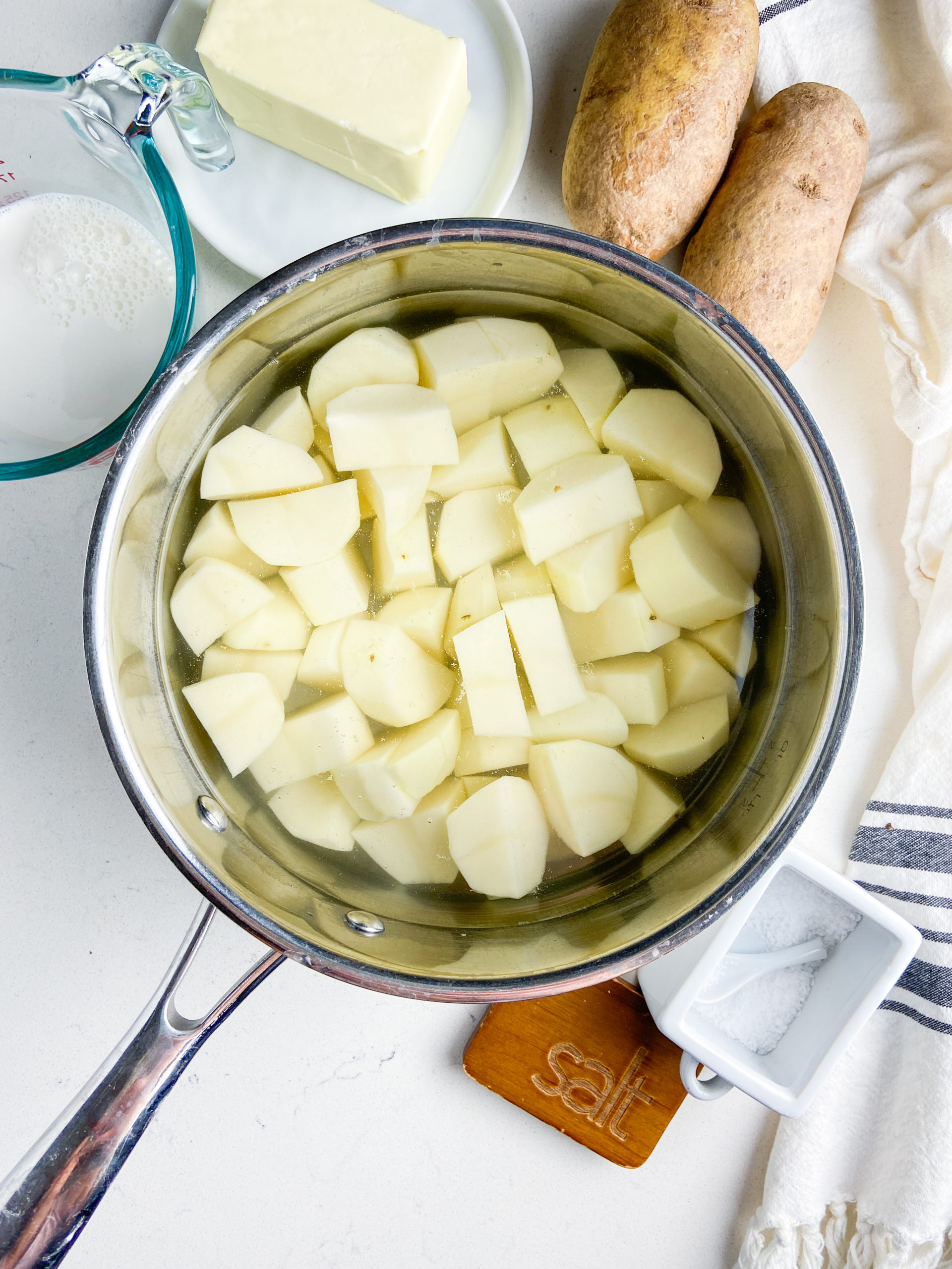 Overhead photos of ingredients needed for mashed potatoes. 