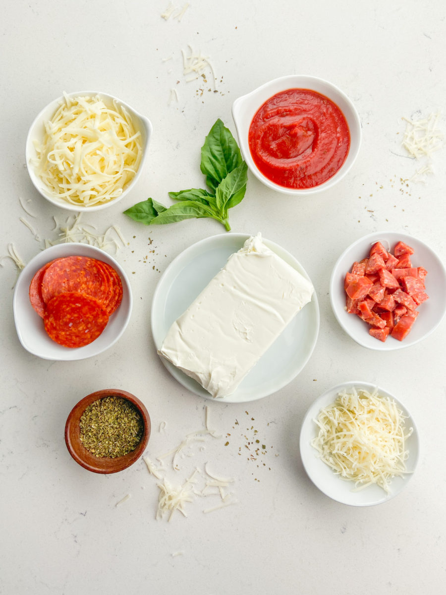 Overhead photos of pizza dip ingredients on white background. 