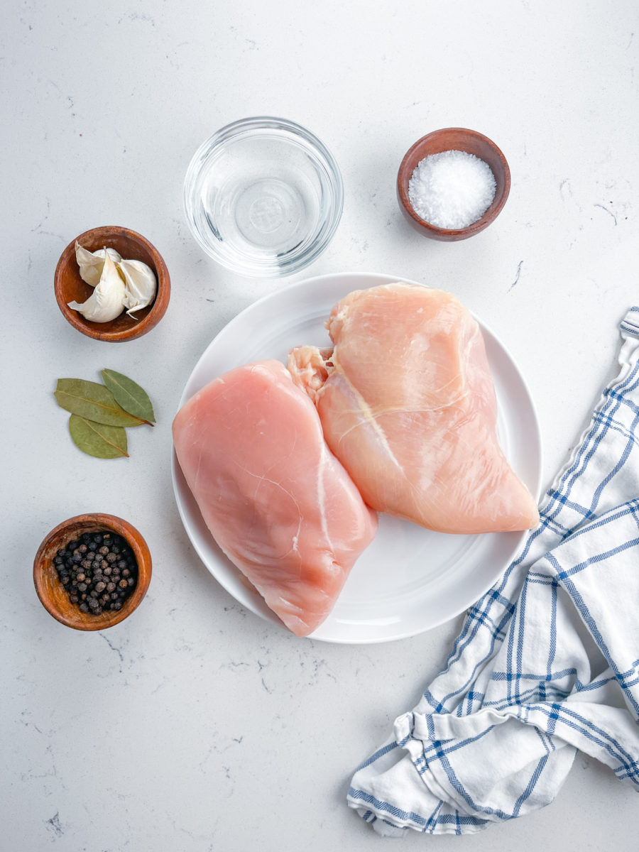 Poached chicken breast ingredients on white background. 