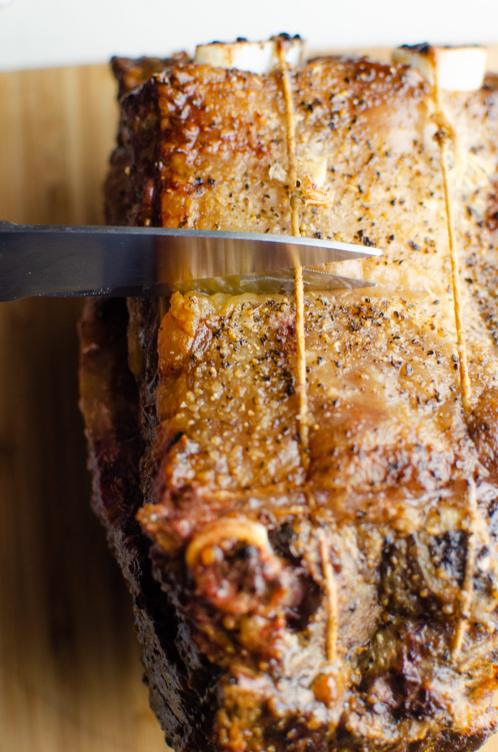 Cutting the string on prime rib roast. 