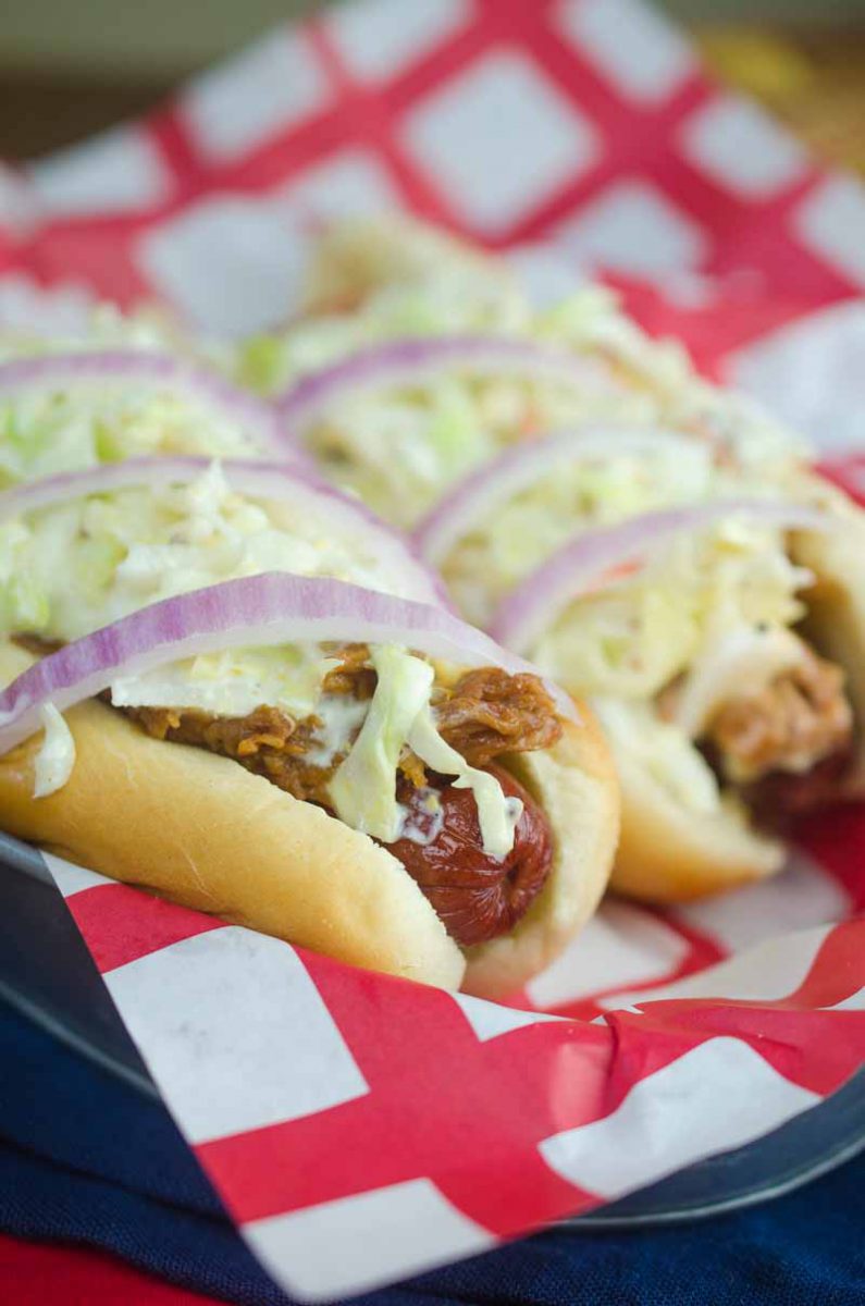 Take your summer hot dogs to the next level with Pulled Pork Hot Dogs. Hot dogs loaded with pulled pork, creamy coleslaw and red onion.