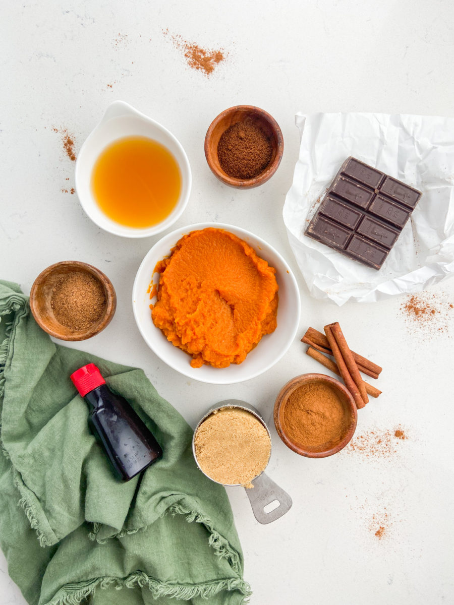 Overhead photo of pumpkin butter ingredients on white background. 