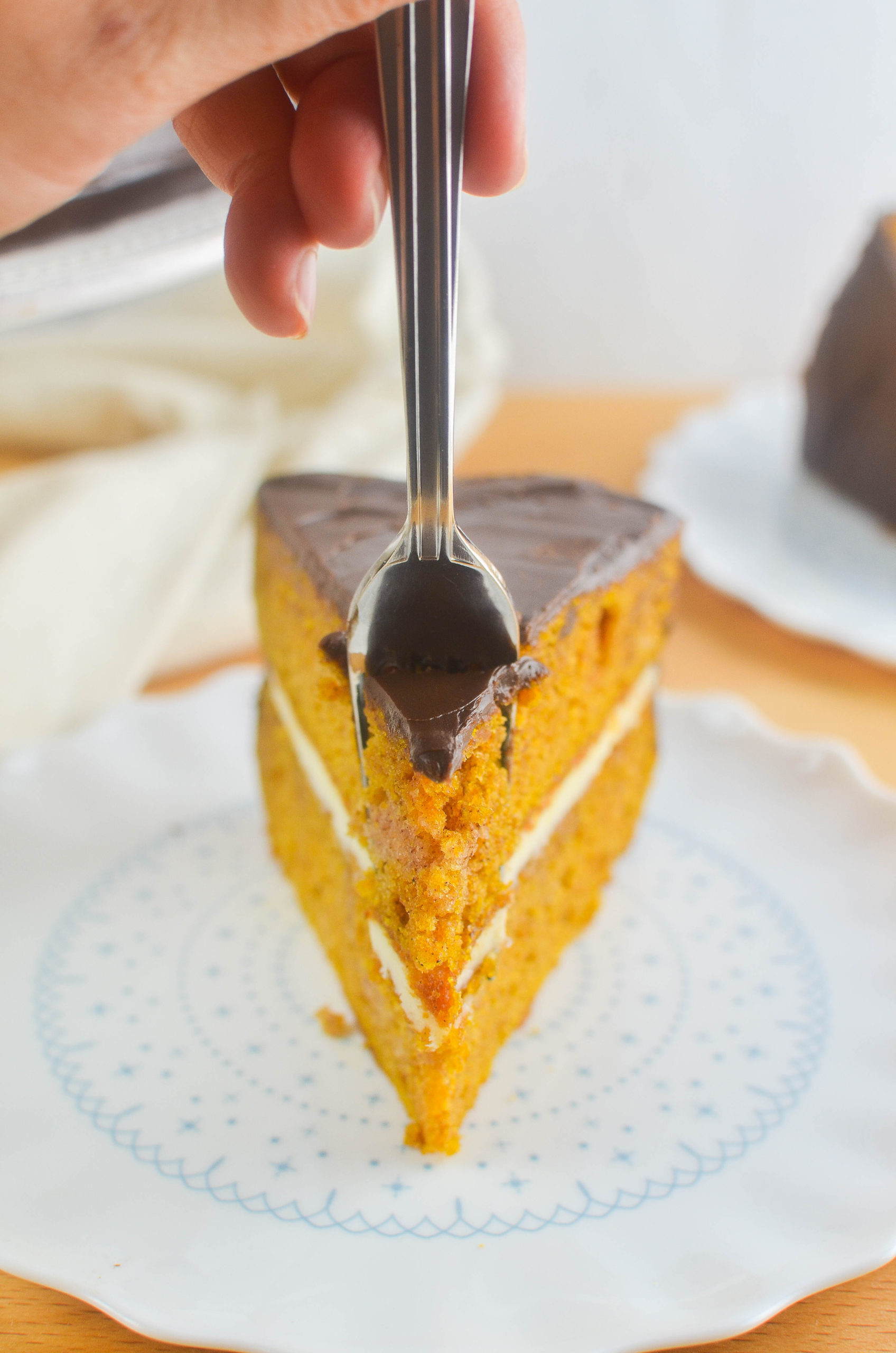 Fork taking a piece of pumpkin cake. 