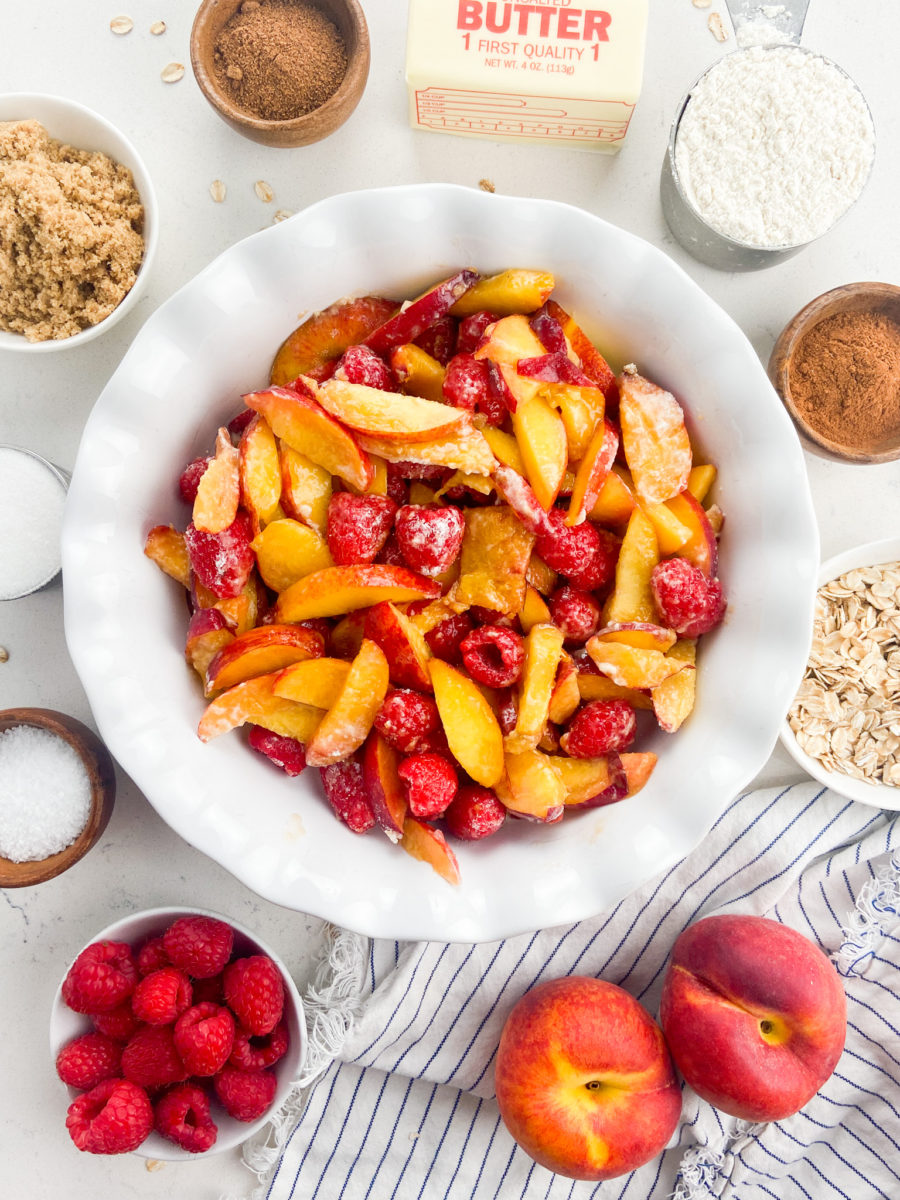 Peaches and raspberries fruit filling in pie dish. 