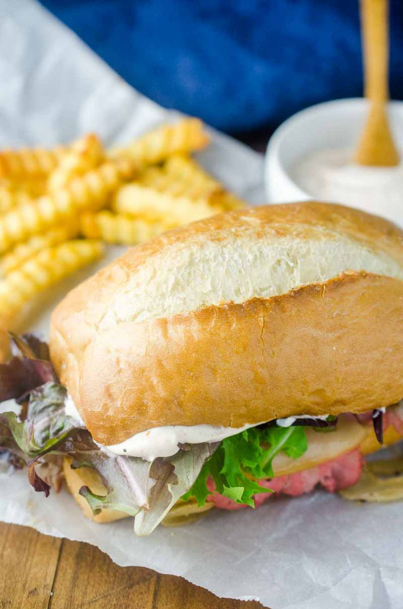 The Best Roast Beef Sandwich loaded with thinly sliced roast beef, caramelized onions, lettuce and a creamy horseradish sauce.