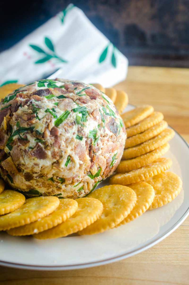 This Roasted Garlic Cheese Ball is a party must have. With Roasted Garlic, Bacon, Goat Cheese and Chives, this Easy Cheese Ball Recipe will be a favorite for years to come! 