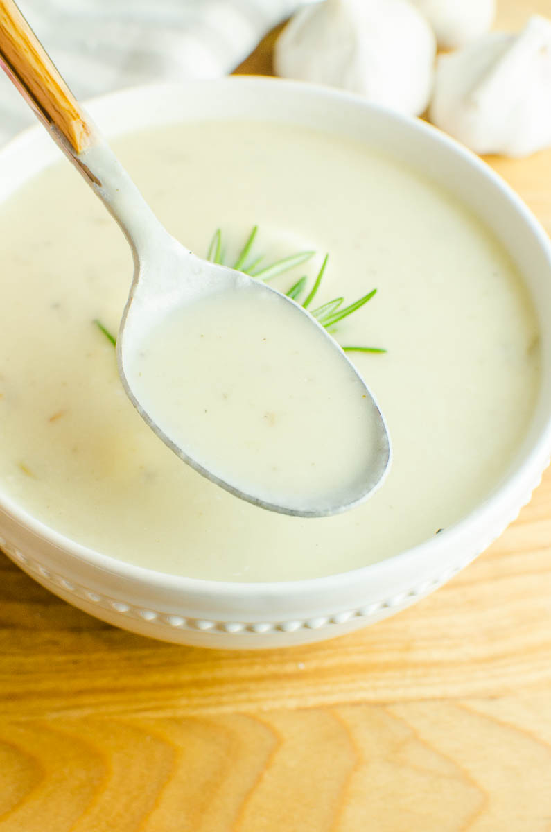 A spoonful of roasted garlic soup. 