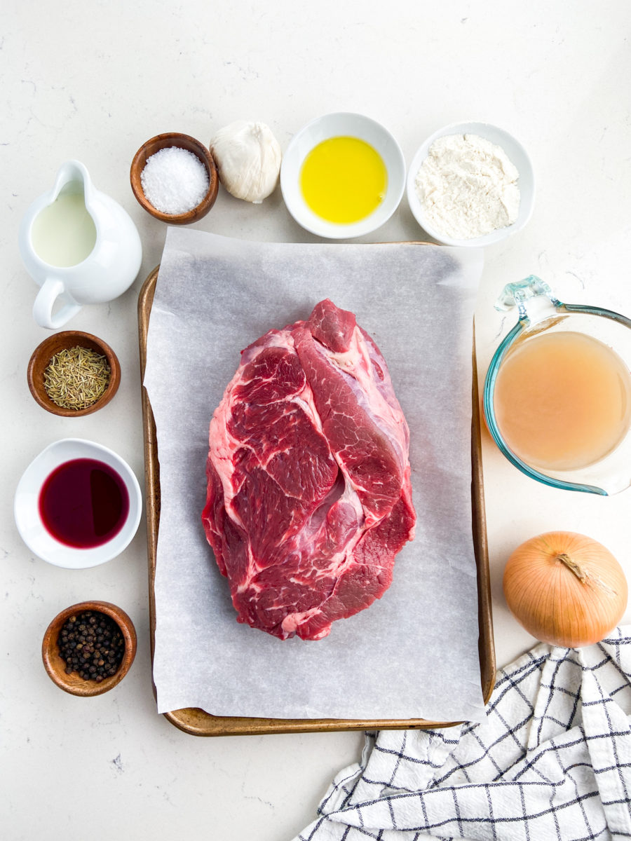 Overhead ingredients of Rosemary pot roast on white background. 