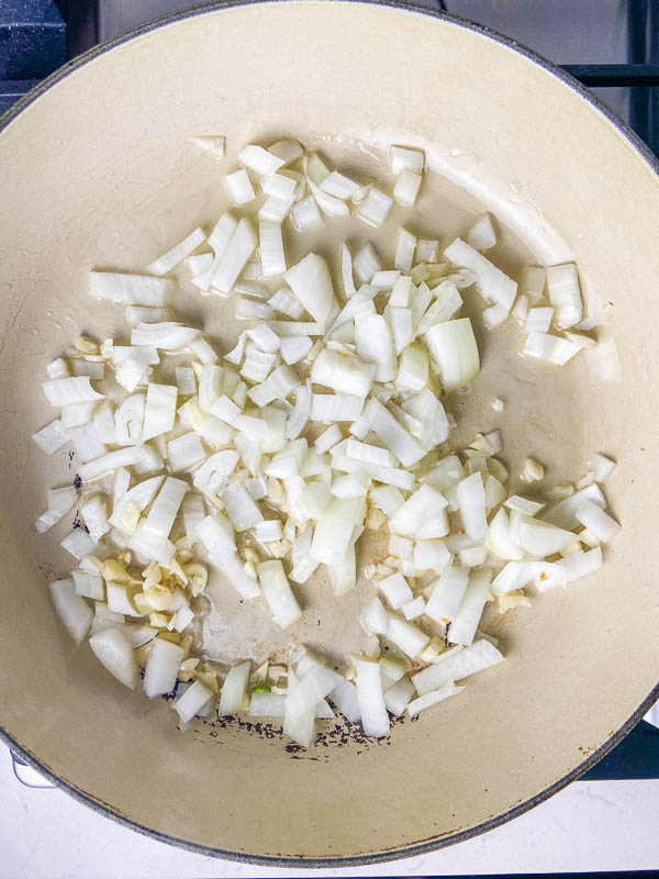Onions and garlic sautéing in a pan. 