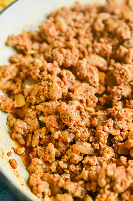 Side angle photo of seasoned taco meat in a pan. 