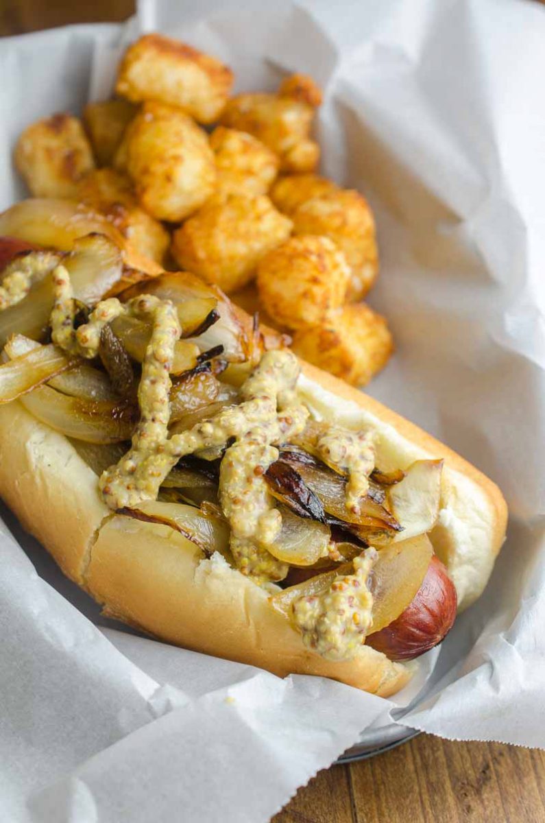 The Seattle Dog is Hot Dog Perfection. A perfectly cooked sausage slathered with cream cheese, and topped with caramelized onions and tangy mustard. 