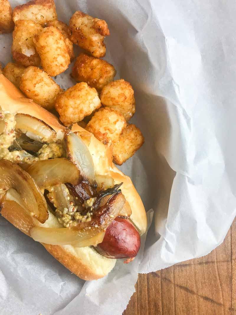 The Seattle Dog is Hot Dog Perfection. A perfectly cooked sausage slathered with cream cheese, and topped with caramelized onions and tangy mustard. 