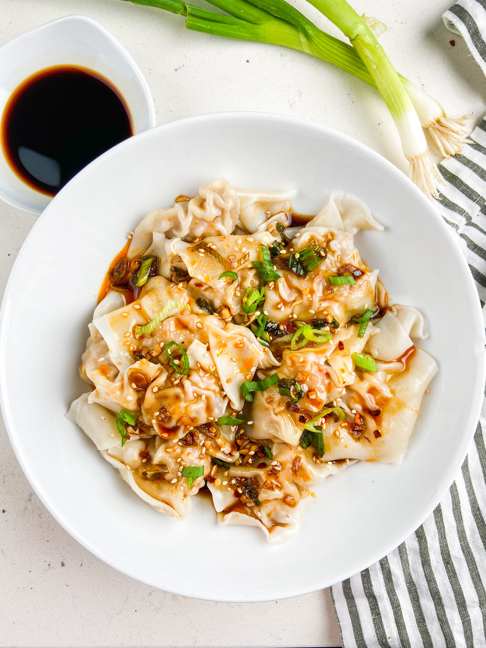 Overhead photo of shrimp and pork wontons in a white bowl. 