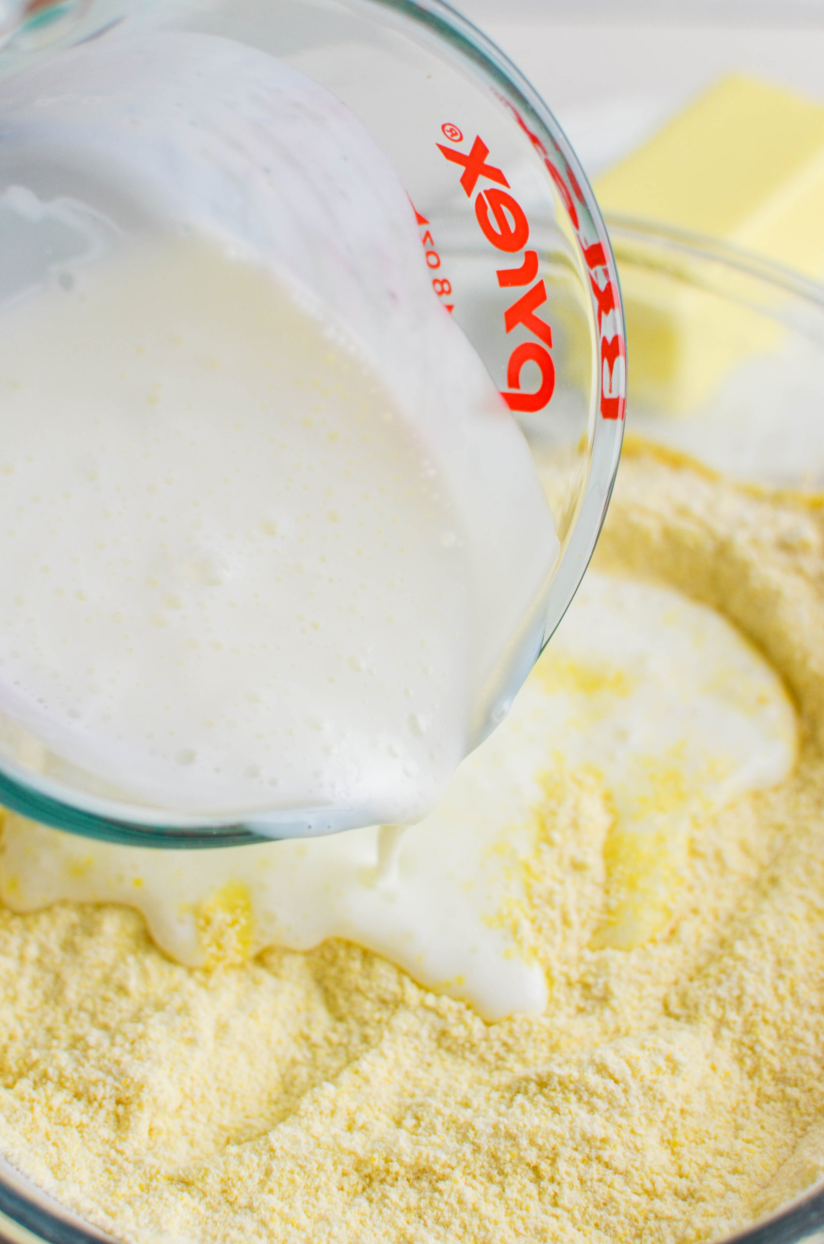 Pouring buttermilk into batter. 