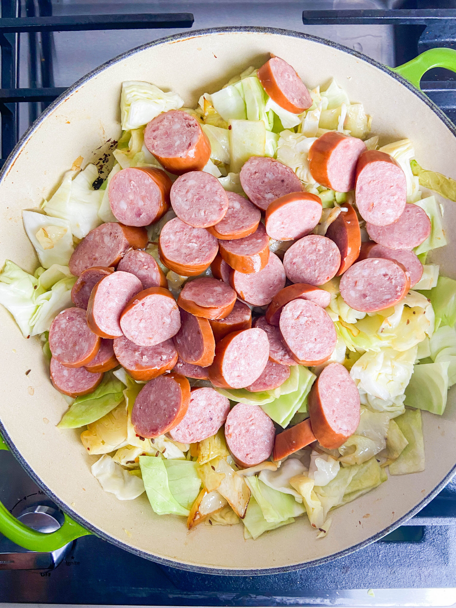 Sauteed cabbage and kielbasa in a skillet. 