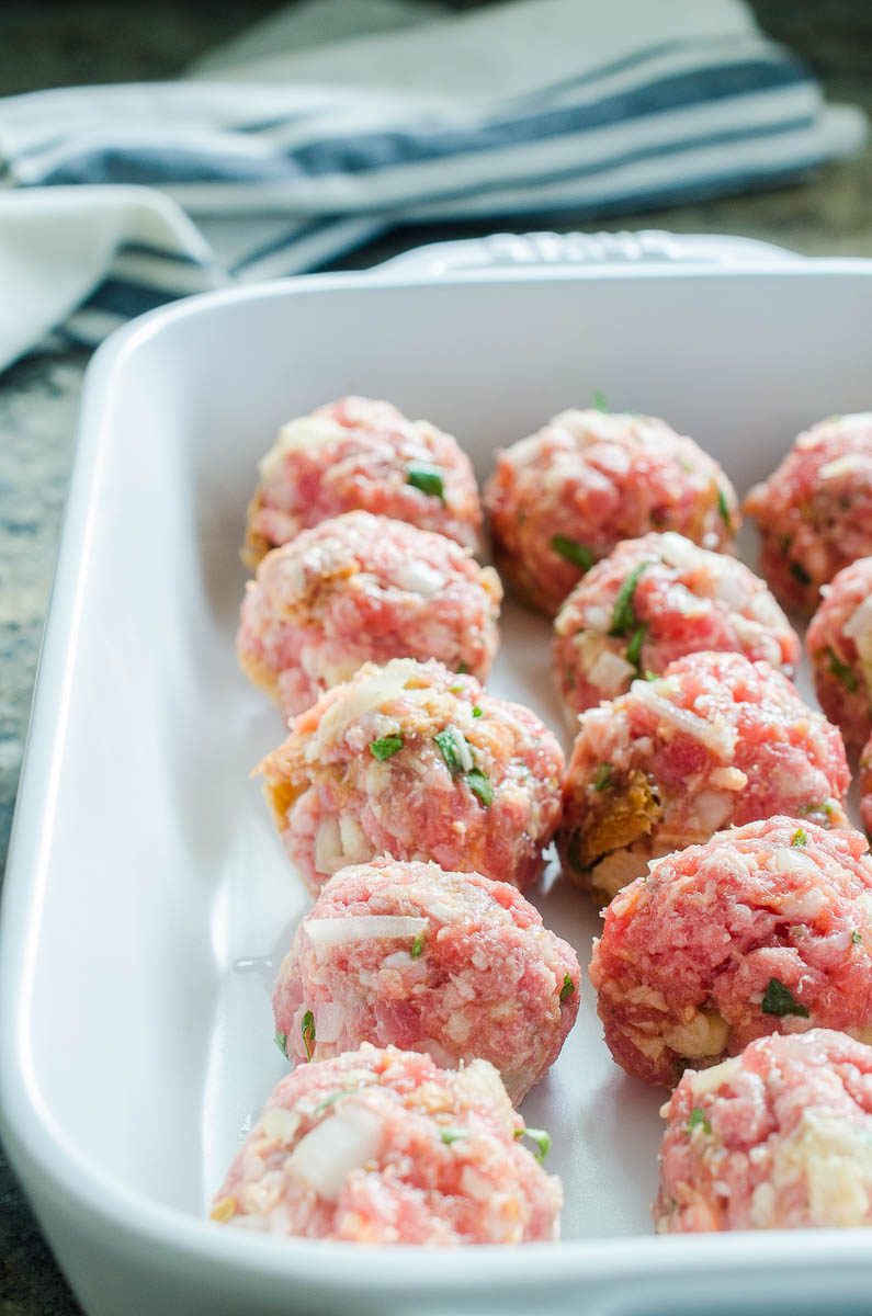 Rolled meatballs in a baking dish. 