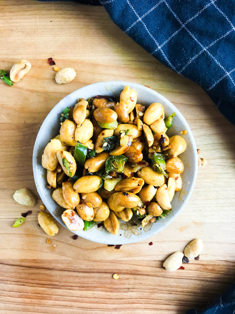 Spicy Fried Peanuts are your new favorite snack! These peanuts are fried in hot oil, sesame oil, garlic, Serrano peppers and crushed red peppers. A little heat and a whole lot of flavor! 