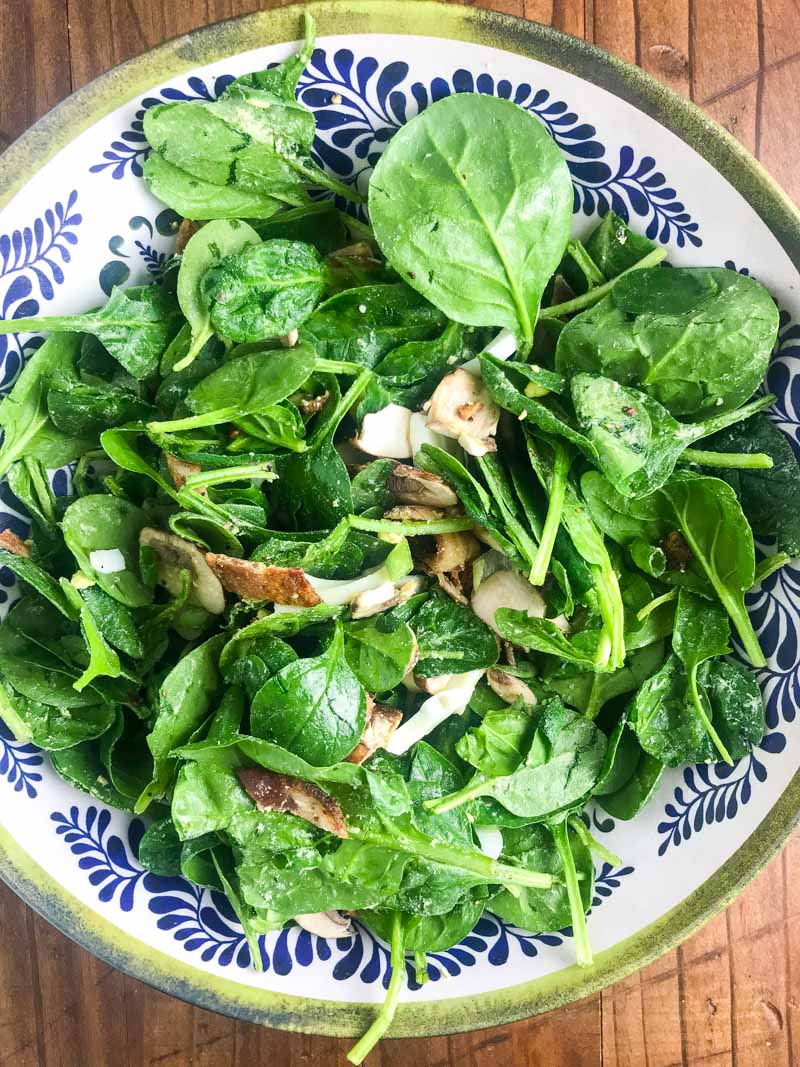 Spinach Salad with Bacon Dressing is a classic for a reason. Fresh spinach tossed with mushrooms, crispy bacon, hard boiled eggs and tossed with a warm bacon dressing. 