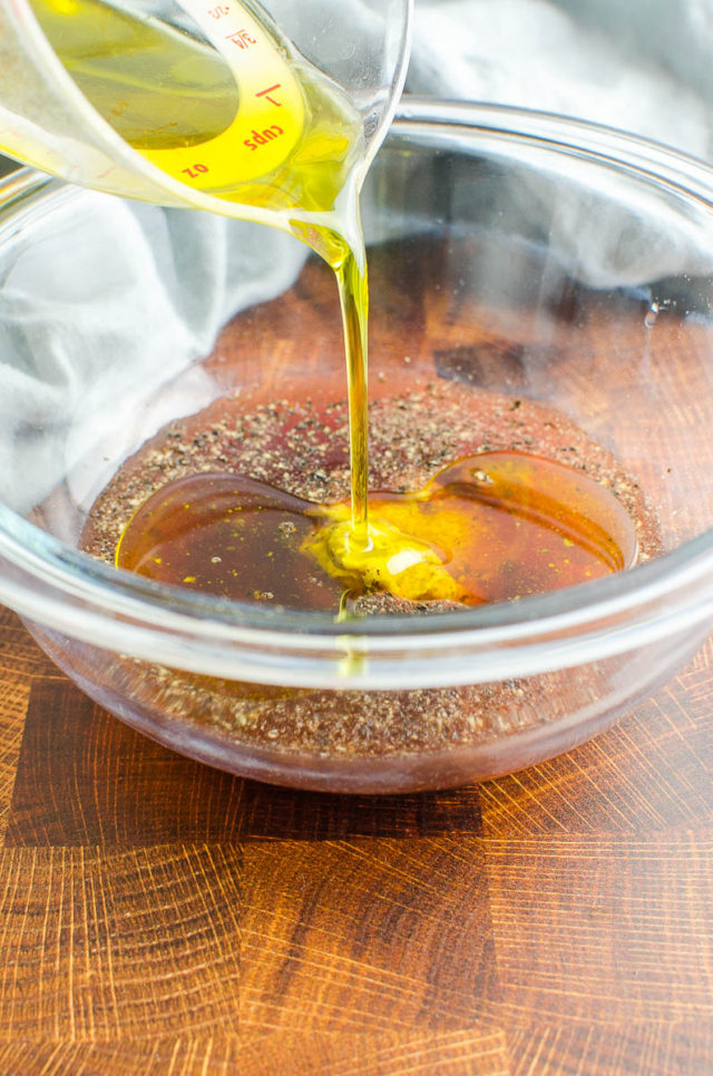 Pouring extra virgin olive oil into dressing bowl. 