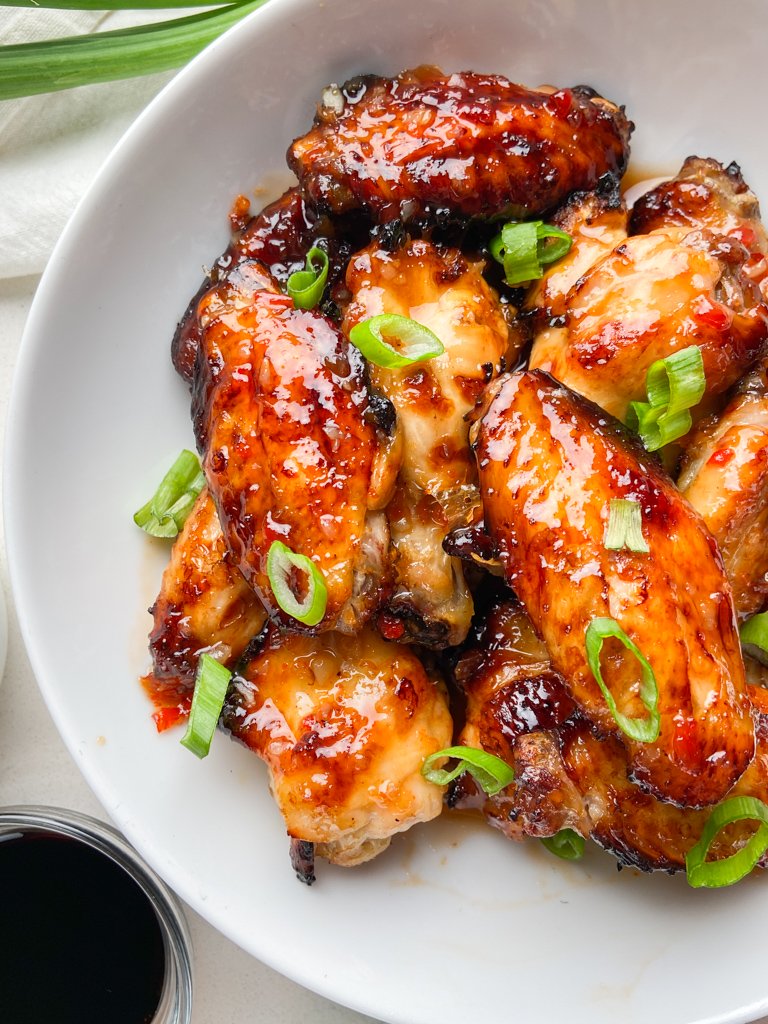 Overhead photo of sweet chili chicken wings in a white bowl 