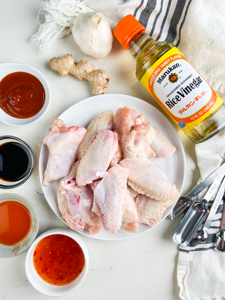 Overhead photo of ingredients needed to make sweet chili chicken wings on a white background. 