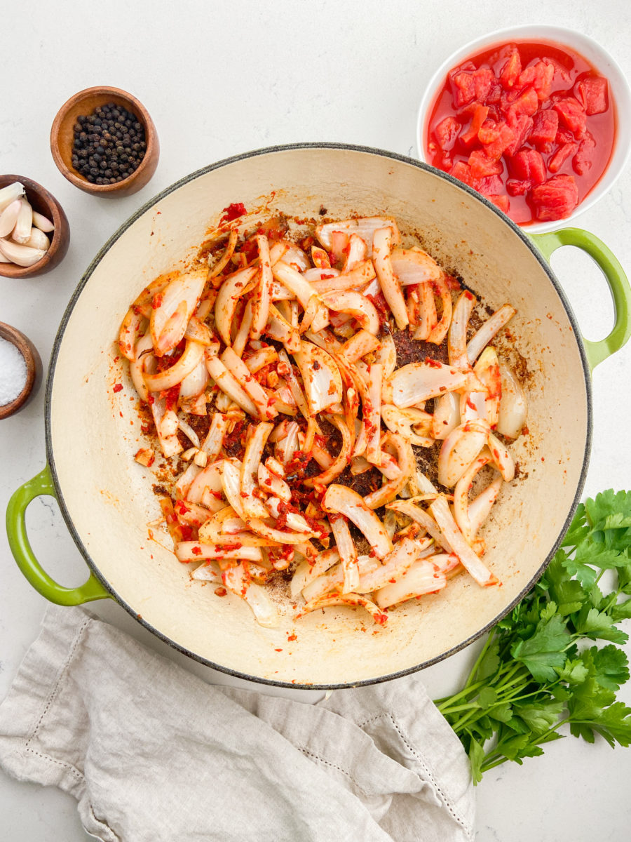 Sauteing onions with tomato paste and seasonings.