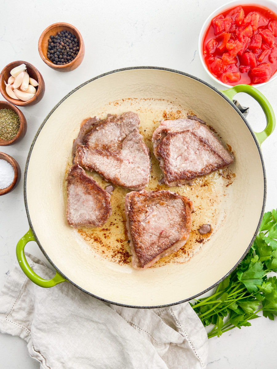 Browning round steak in braising pan.