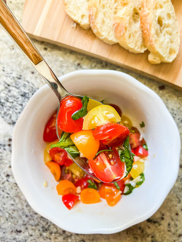 A spoonful of tomato bruschetta topping. 