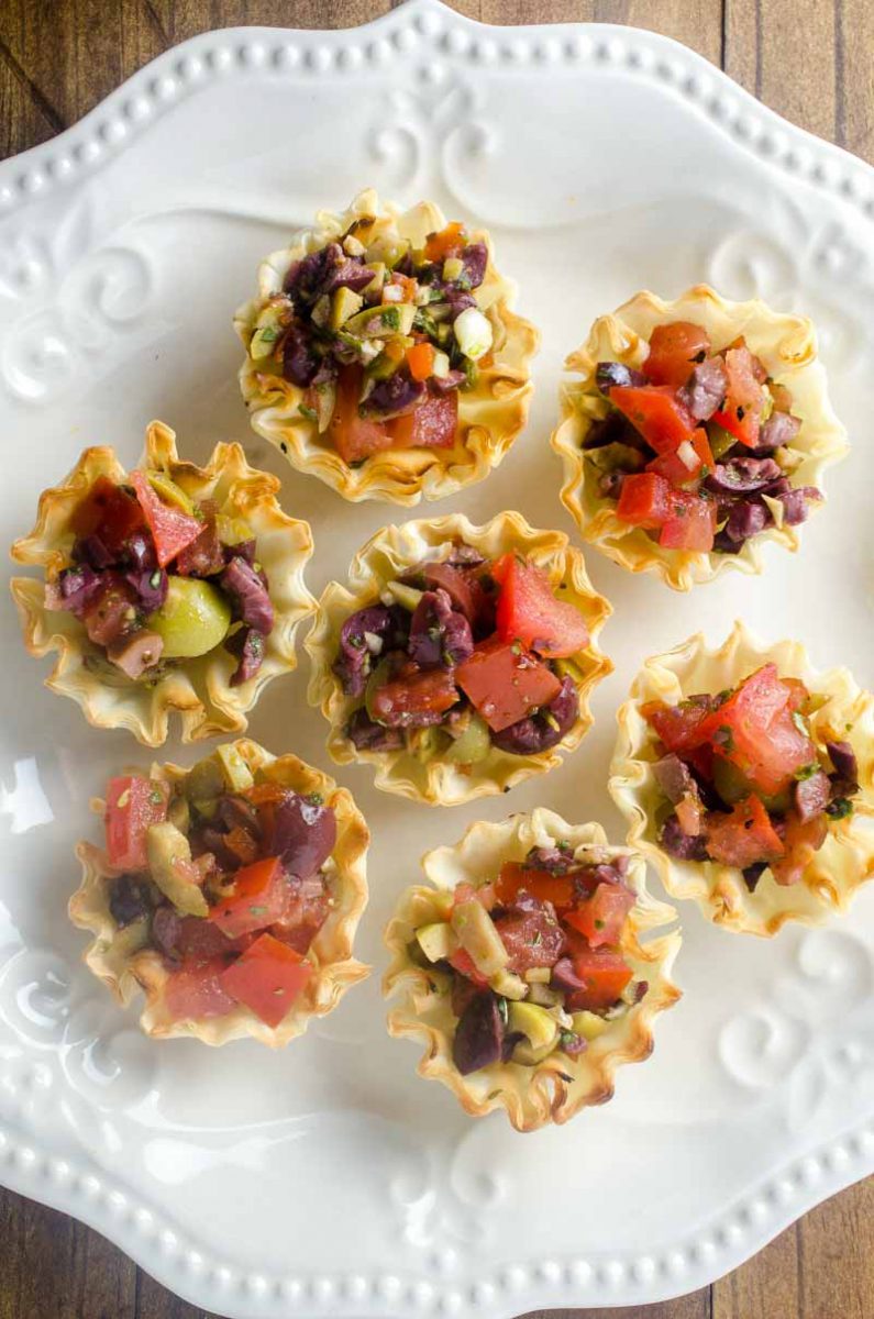 Tomato Olive Phyllo Cups are the perfect party appetizer. Fresh tomatoes and briny olives piled high in crispy phyllo cups. Ready in less than 10 minutes! 