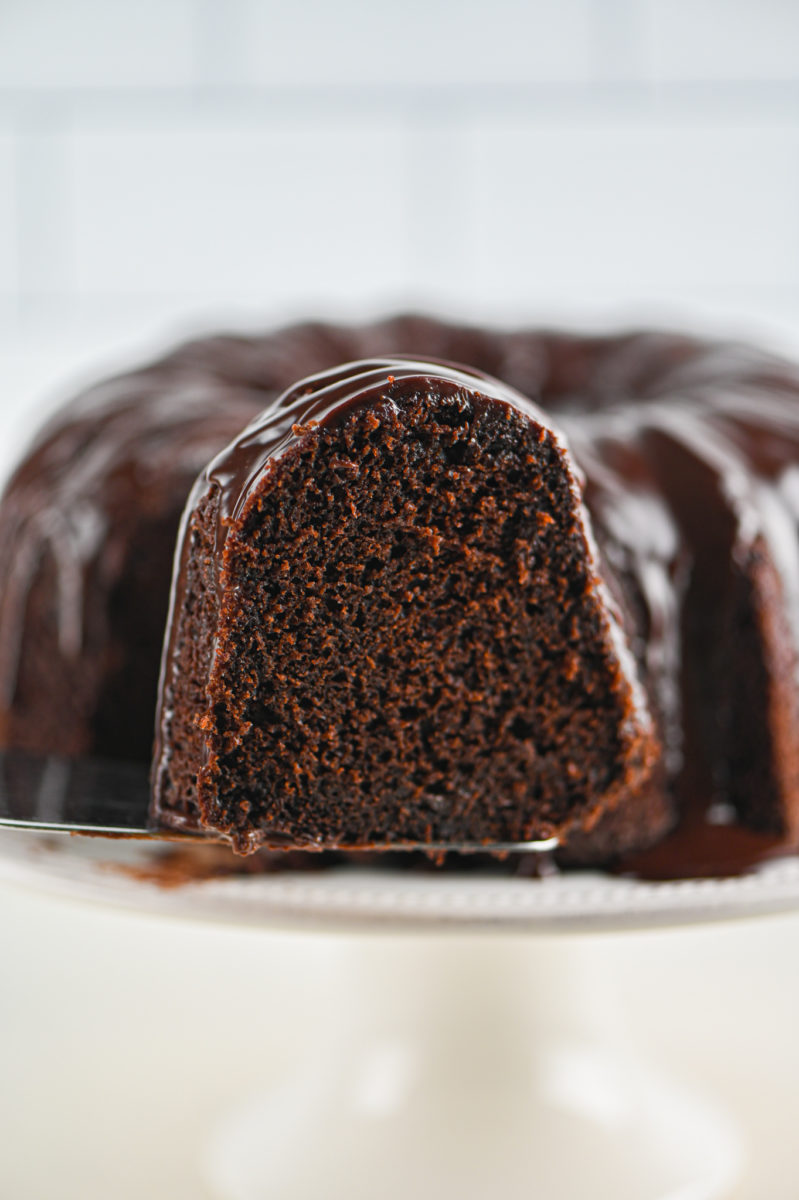 Serving a slice of triple chocolate bundt cake. 