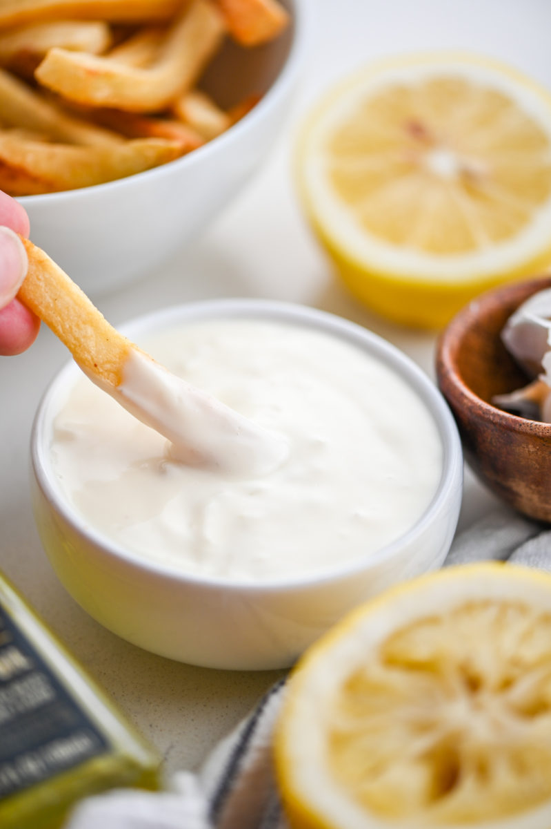 French fry dipping in Truffle Aioli.
