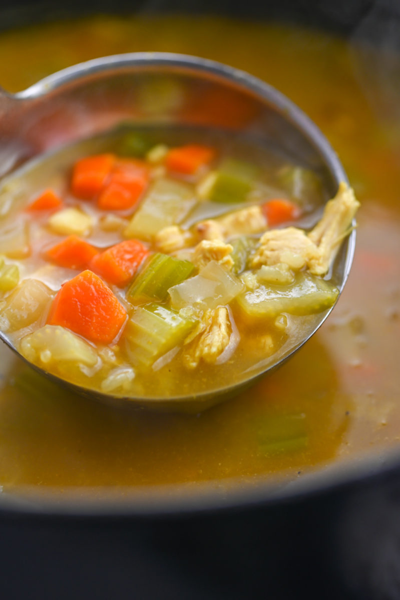 A ladle of turkey curry soup. 