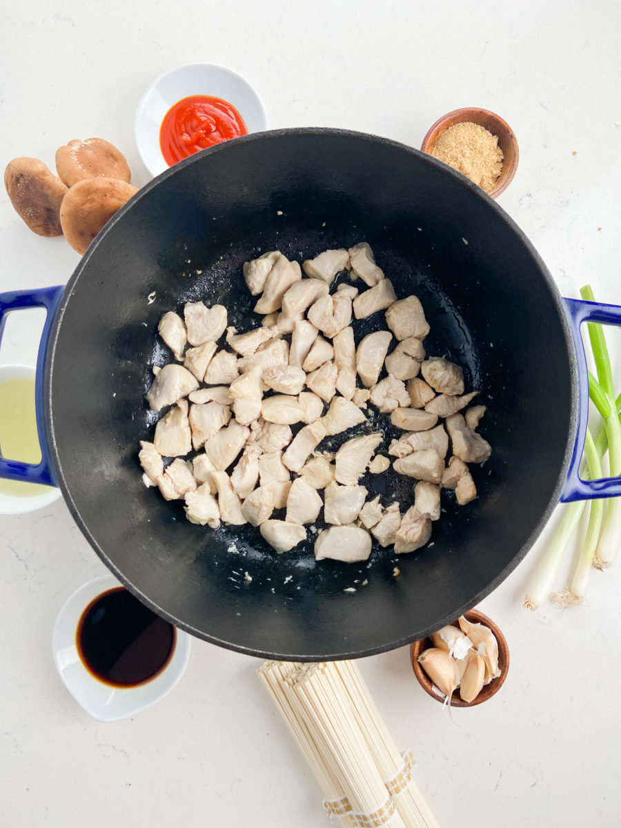 Browning chicken pieces in pot. 