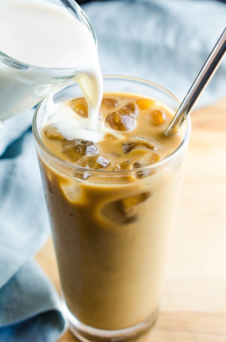 Pouring vanilla sweet cream into ice coffee