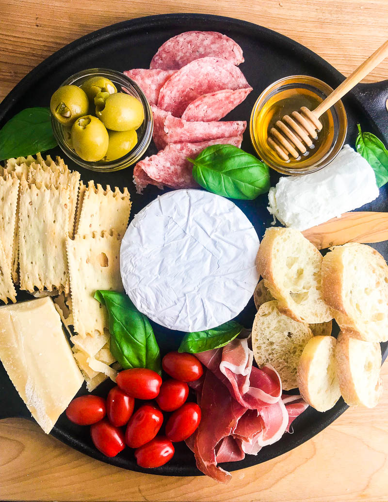 This Summer Charcuterie Board is loaded with 3 different kinds of cheese, meat, olives, tomatoes, crackers and sweet honey. It's perfect for all of your snacking this summer. 