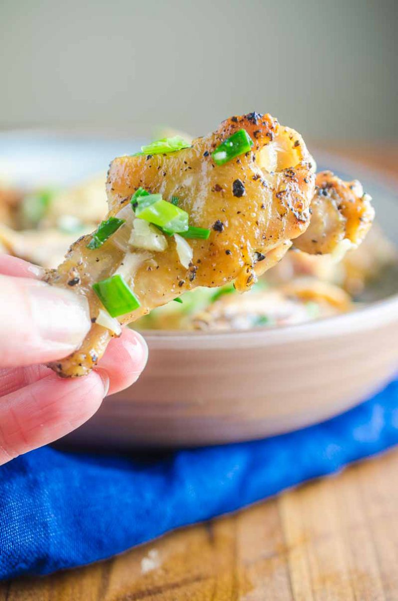 Baked Salt and Pepper Chicken wings are baked until crispy and tossed in a mixture of sesame oil, jalapeños, garlic and green onions.